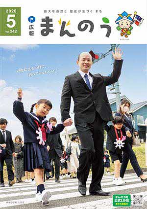広報まんのう5月号の表紙写真（仲南小学校の入学式後に行われた交通安全教室で父親と一緒に横断歩道を渡っている様子）